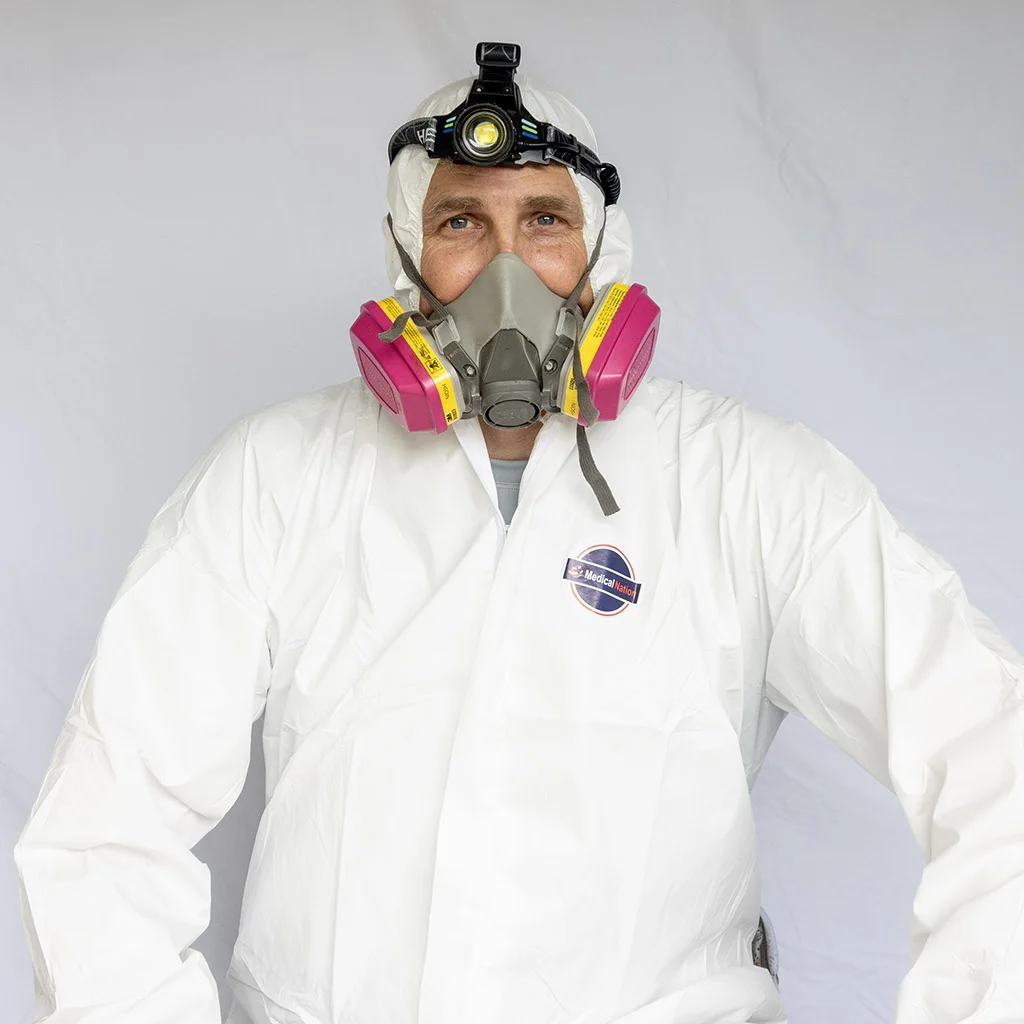 Kit Brucker in a protective suit, respirator and headlamp